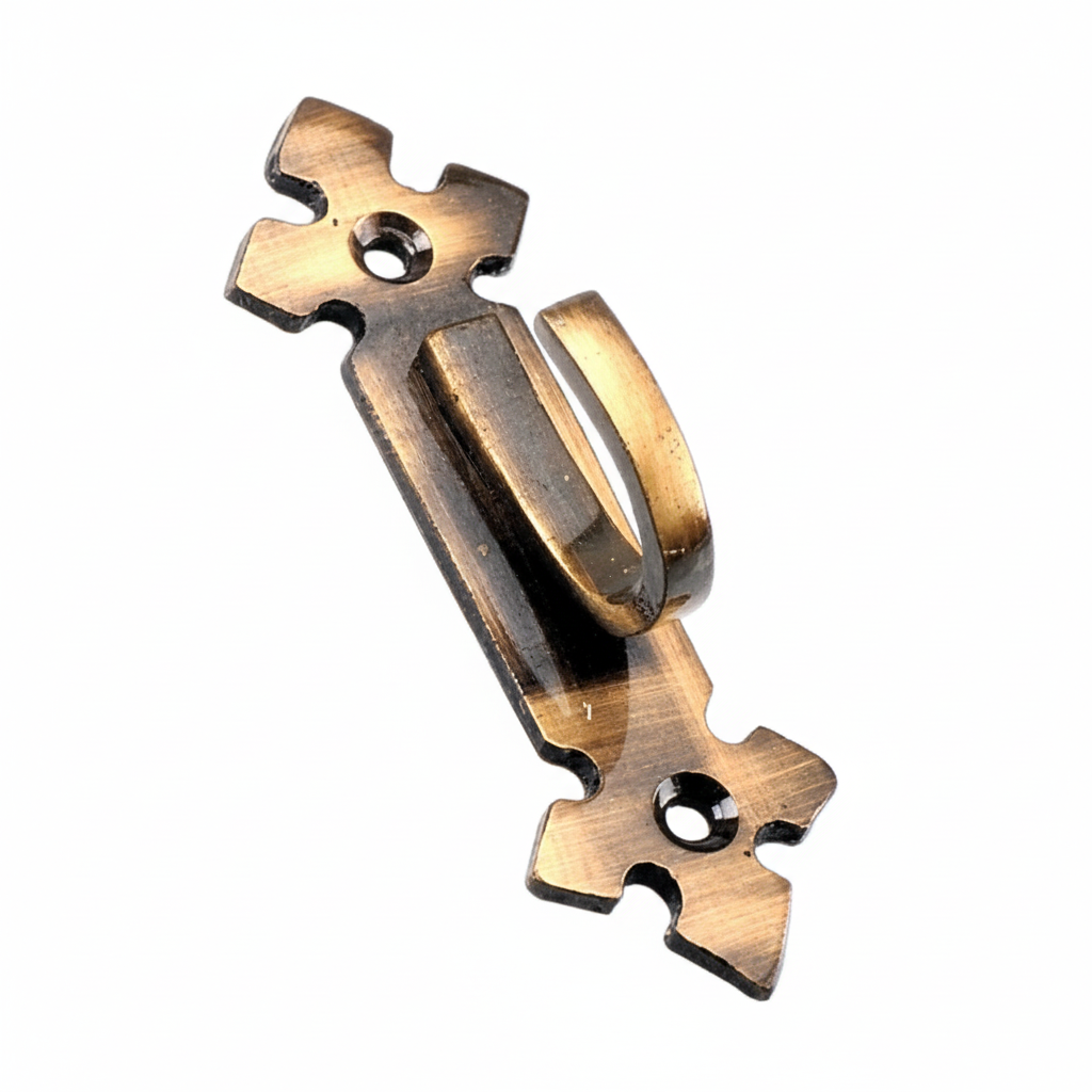 A single decorative wall hook crafted from solid metal with an antique brass finish, featuring a stylized fleur-de-lis backplate with two pre-drilled mounting holes and a sturdy curved hook for hanging keys, hats, or curtain tiebacks.