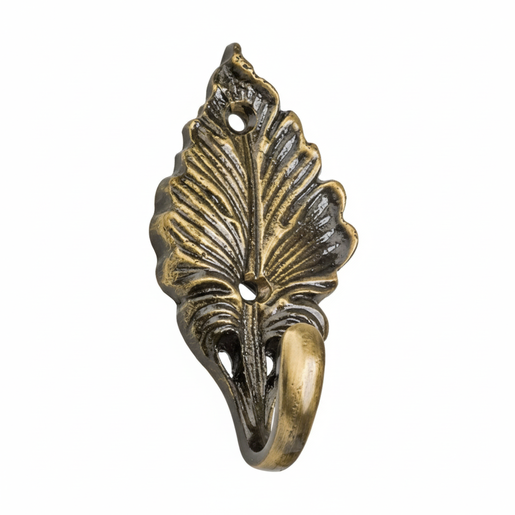 An ornate decorative wall hook featuring a highly detailed leaf design with prominent veining in an antique brass finish. The botanical-style hardware includes two pre-drilled mounting holes and a smooth curved hook for hanging keys, jewelry, or light accessories.