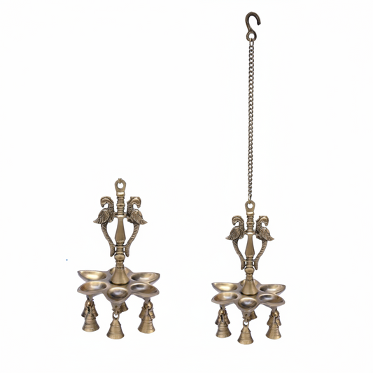 Traditional Fab2277 antique brass hanging diya featuring twin peacock motifs, five oil wick compartments, and five decorative small bells suspended from a metal link chain.