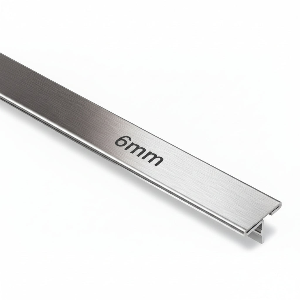 A high-precision 6mm T-shaped metal profile featuring a premium brushed stainless steel finish. This architectural trim is designed for decorative inlays in furniture, wall paneling transitions, and floor dividers, showcasing a clean shadowless aesthetic for modern interior design.