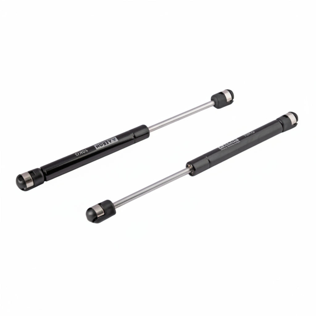 A pair of Aeron 9-inch hydraulic gas pumps in a sleek black finish, each with a 10kg load capacity. These professional-grade pneumatic lift supports feature high-pressure cylinders and reinforced ball joint connectors for smooth, silent operation. Ideal for providing controlled lift and hold for kitchen cabinet doors, storage lids, and lightweight furniture panels.