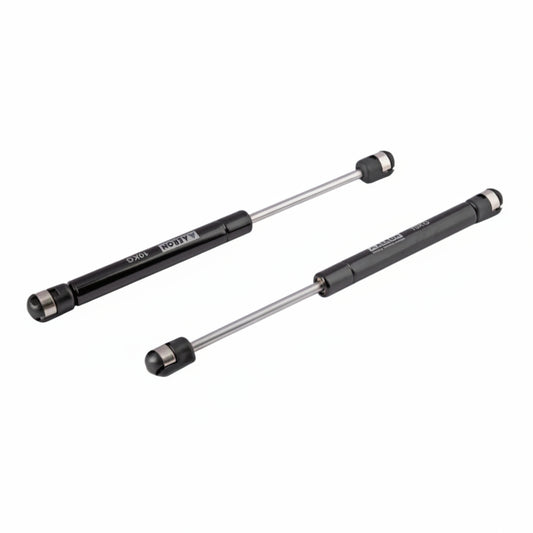 A pair of Aeron 9-inch hydraulic gas pumps in a sleek black finish, each with a 10kg load capacity. These professional-grade pneumatic lift supports feature high-pressure cylinders and reinforced ball joint connectors for smooth, silent operation. Ideal for providing controlled lift and hold for kitchen cabinet doors, storage lids, and lightweight furniture panels.