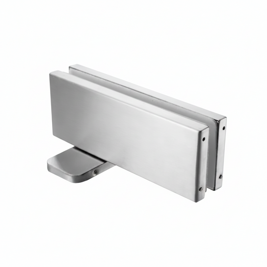 A heavy-duty bottom patch fitting for frameless glass doors, featuring a high-quality brushed stainless steel finish and a rectangular profile designed for secure floor pivot mounting in commercial or residential glass entryways.