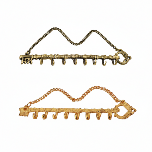Two decorative wall hook racks shaped like large vintage skeleton keys, featuring eight small hooks each and an attached hanging chain. The two metallic finishes:  antique brass and gold.