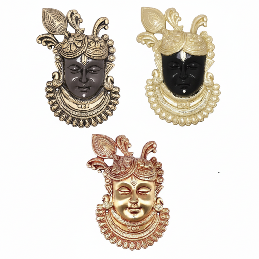 Decorative  of Lord Krishna (Kanha) face wall hangings featuring traditional peacock feather crowns and ornate jewelry. The set includes three distinct color variations: an antique bronze finish, a high-contrast black and gold finish, and a radiant polished gold finish for home temple or living room decoration.