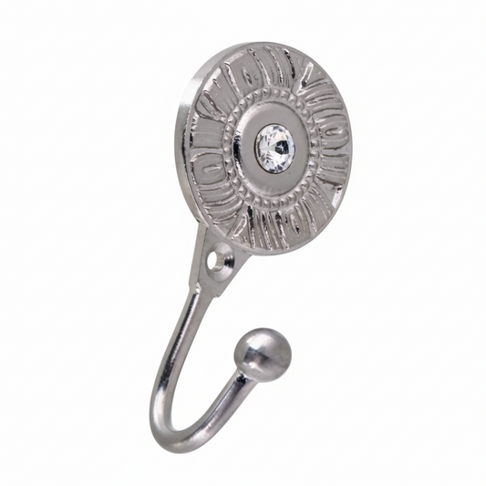 A decorative silver wall hook featuring a circular sunburst backplate with an embedded clear crystal at the center. The hardware has a polished chrome, a single mounting hole, and a sturdy curved hook ending in a smooth ball tip for hanging accessories.