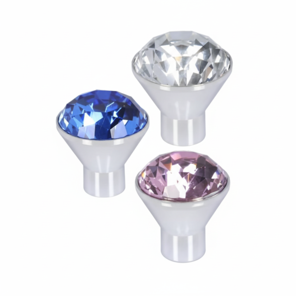 A set of three premium cone-shaped cabinet knobs in a polished chrome finish, each featuring a large faceted crystal gemstone. The collection includes a vibrant sapphire blue,rose pink, and clear crystal, designed for luxury kitchen cabinets, dressers, and vanity drawers.
