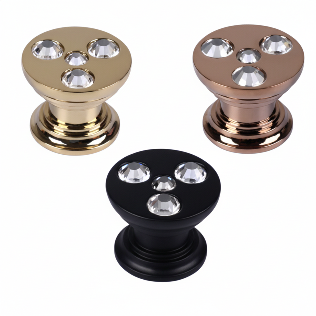 A set of three high-end cabinet knobs with a flat circular top embedded with four clear faceted crystals. The image showcases three elegant finish options: polished gold, rose bronze, and black, designed for luxury kitchen cabinets, wardrobes, and vanity drawers.