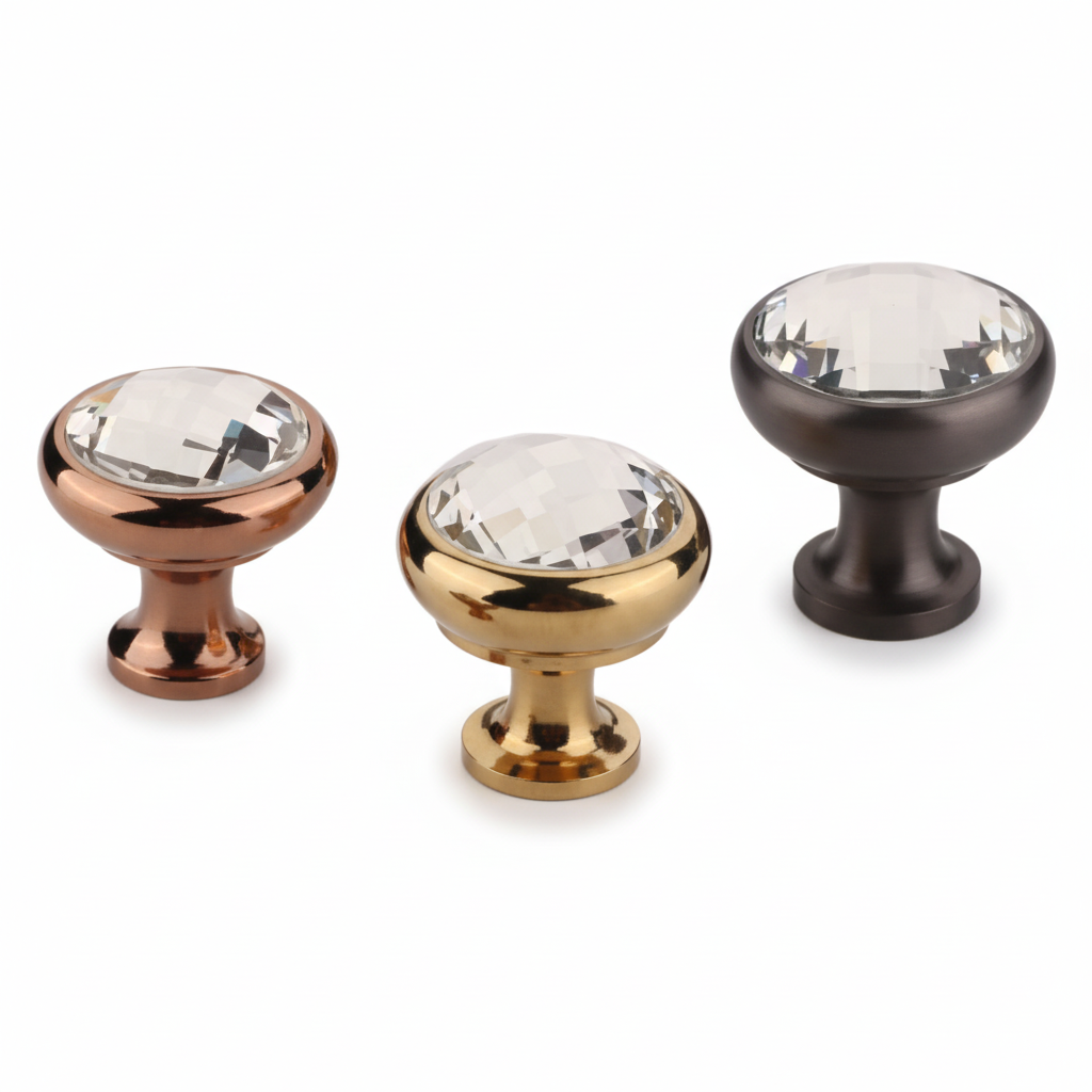 A set of three premium round cabinet knobs featuring large faceted clear crystals inset into smooth metallic bases. The assortment showcases three elegant finish options: rose gold, antique brass, and grey, designed for luxury kitchen cabinetry, dressers, and vanity drawers.