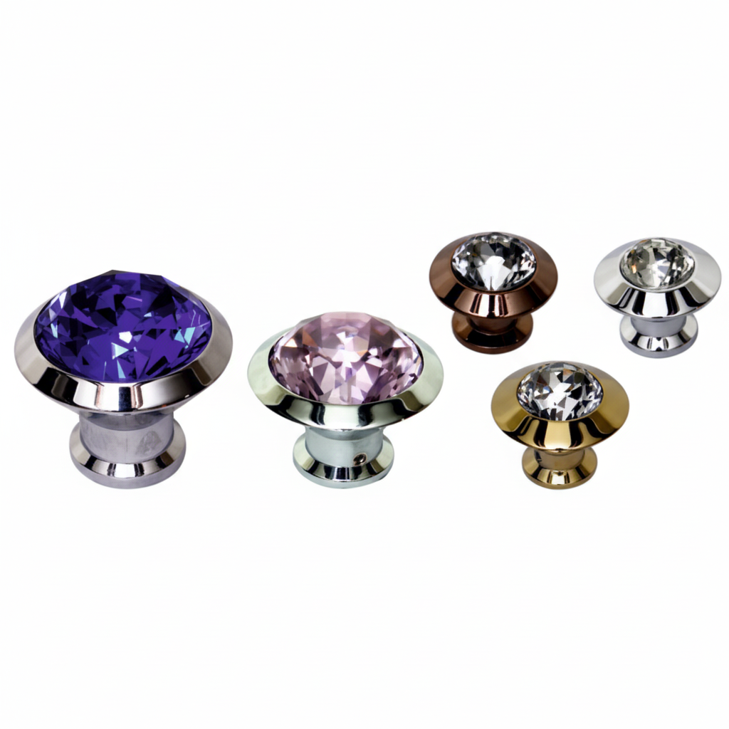 A collection of five luxury cabinet knobs featuring large faceted crystals in metallic bases. The assortment includes a large amethyst purple crystal, a rose pink crystal, and three clear crystals set in various premium finishes including polished gold, sleek chrome, and rich antique brass.