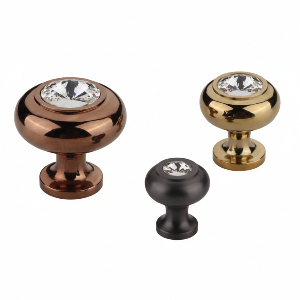 A set of three premium round cabinet knobs featuring large faceted clear crystals inset into smooth metallic bases. The assortment showcases three elegant finish options: antique brass, gold, and  matte black, designed for luxury kitchen cabinetry, dressers, and vanity drawers.