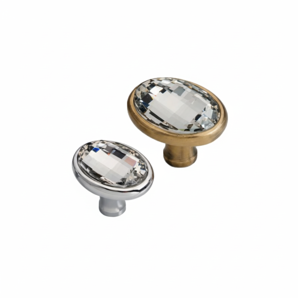 Two premium oval cabinet knobs featuring large faceted clear crystals set into elegant metallic bases. The image showcases two finish options: a modern polished chrome and antique brass, ideal for luxury kitchen cabinetry, dressers, and vanity drawers.