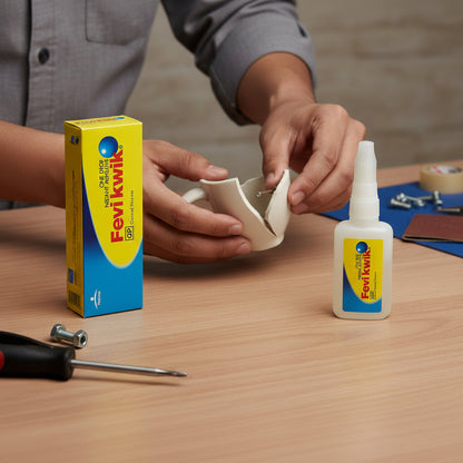 Person using Fevikwik glue on a small white object with the product packaging visible.