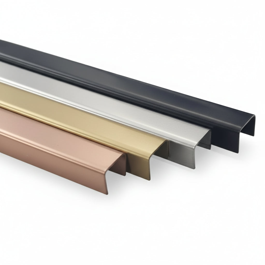 A collection of four high-quality U-shaped metal edge trims displayed in premium finishes: matte black, satin nickel, brushed gold, and rose gold. These architectural stainless steel profiles are designed for edge protection and decorative inlay in luxury furniture, cabinetry, and wall paneling projects.
