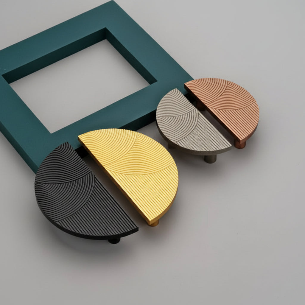 A luxury collection of Creatick DH-103 modern half-moon cabinet handles featuring a sophisticated concentric circular texture. These artistic semi-circle furniture pulls are shown in matte black, polished gold, satin silver, and brushed copper finishes—perfect for minimalist kitchen cabinetry, designer wardrobes, and contemporary interior hardware.