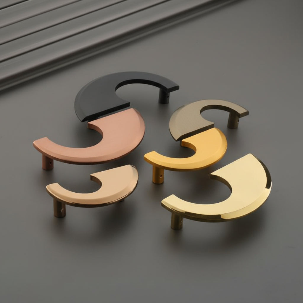 A collection of Creatick DH-108 modern cabinet handles featuring a unique, sleek crescent moon or "C" shaped geometric design. These artistic furniture pulls are shown in matte black, rose gold, satin champagne, and polished gold finishes—perfect for minimalist kitchen cabinetry, luxury wardrobes, and contemporary interior hardware projects.