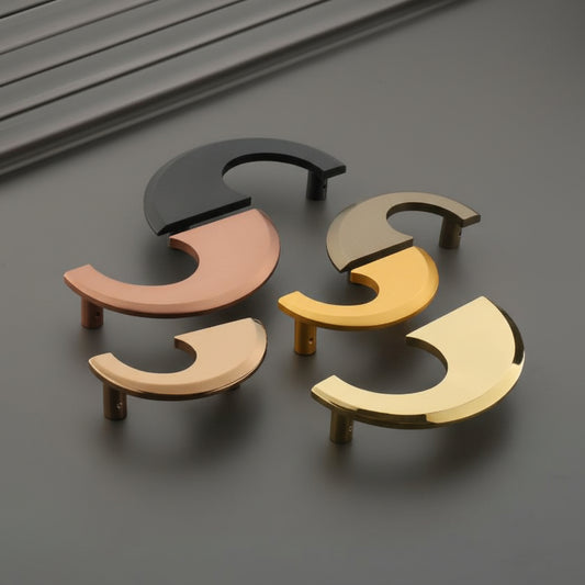 A collection of Creatick DH-108 modern cabinet handles featuring a unique, sleek crescent moon or "C" shaped geometric design. These artistic furniture pulls are shown in matte black, rose gold, satin champagne, and polished gold finishes—perfect for minimalist kitchen cabinetry, luxury wardrobes, and contemporary interior hardware projects.