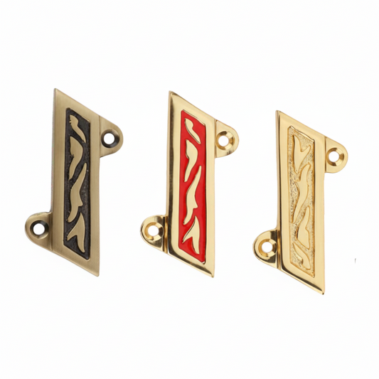 Three Fab 0210 Shree symbols for wall mounting, featuring antique brass with black inlay, polished gold with red enamel (Red Mina), and a textured gold finish, all with intricate vine carvings and integrated mounting holes.
