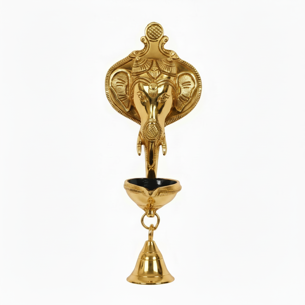 A  gold finish Lord Ganesha wall-hanging diya featuring a detailed Ganesha head backplate, a single-wick oil lamp bowl with a black interior, and a hanging brass bell for home temple or pooja room decoration.
