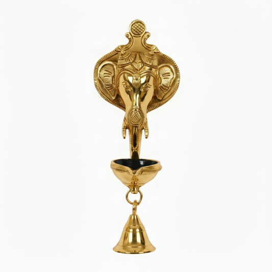 A  gold finish Lord Ganesha wall-hanging diya featuring a detailed Ganesha head backplate, a single-wick oil lamp bowl with a black interior, and a hanging brass bell for home temple or pooja room decoration.