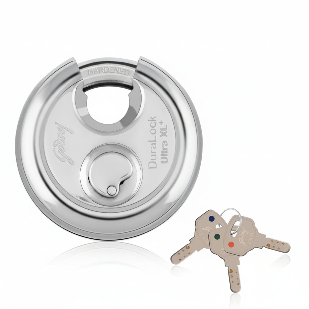Godrej Duralock Ultra XL+ high-security disc padlock in a polished silver finish, featuring a hardened steel shackle, a drill-resistant body, and three computer-aided 'Ultra' dimple keys with color-coded ID tags for easy identification.