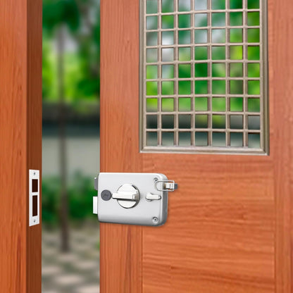 Godrej Twinbolt Ultra XL rim lock in a modern satin nickel finish, installed on a rich-textured wooden main door with a decorative safety grill window, showcasing the robust double-bolt mechanism and internal privacy knob.