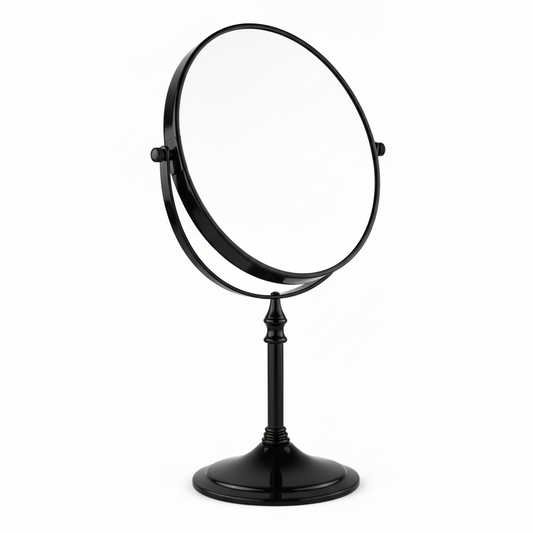 Grafiqe freestanding circular pedestal mirror in a sleek matte black finish, featuring a 360-degree double-sided swivel head for standard and magnified viewing on a stable weighted base.