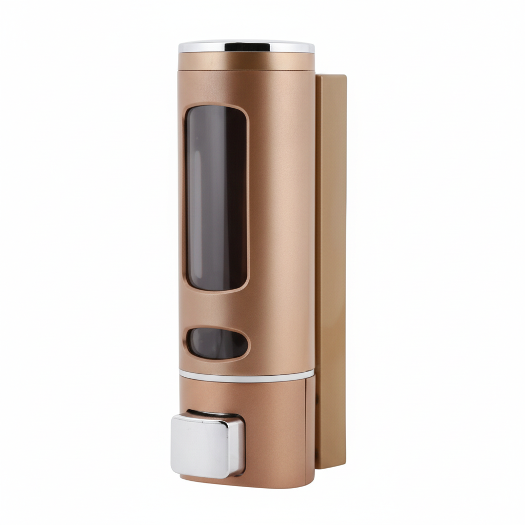 Grafiqe wall-mounted cylindrical liquid dispenser in a matte champagne rose  gold finish, featuring a large transparent viewing window for level monitoring and a chrome manual push-button pump for shower or vanity organization.