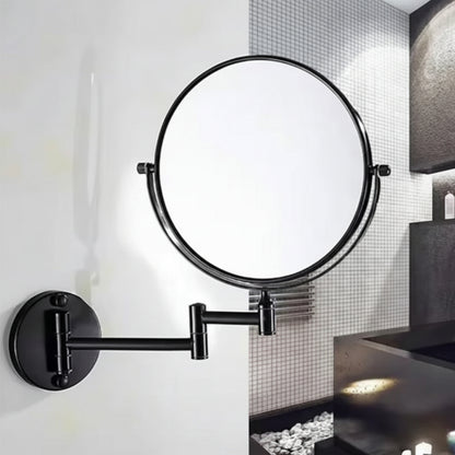 Lifestyle view of a Grafiqe black circular vanity mirror installed on a clean white wall, featuring a telescopic double-swivel arm and a 360-degree rotating head, positioned next to a modern dark-toned bathroom vanity.