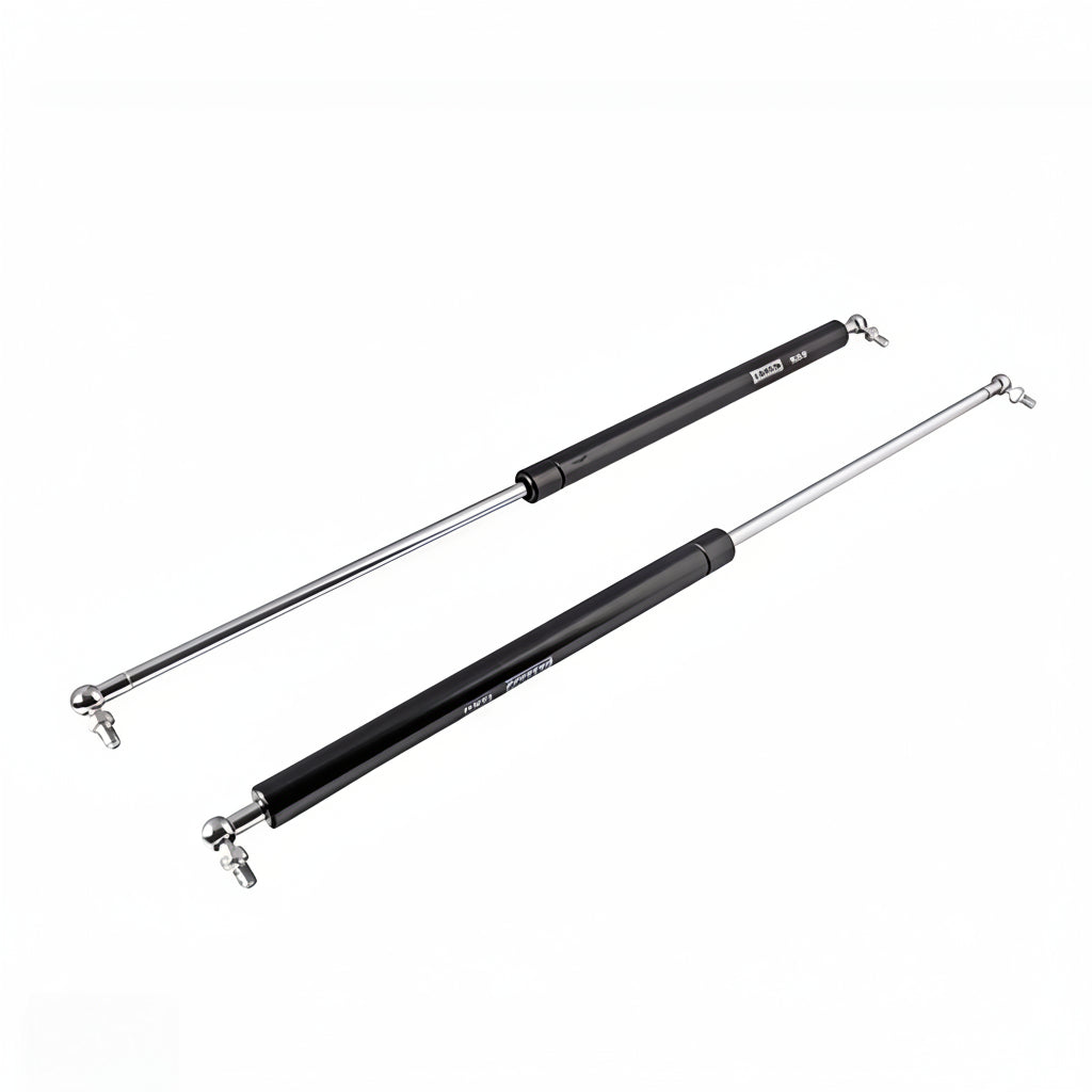 A pair of heavy-duty black gas struts with polished silver hydraulic rods and ball joint connectors. These premium lift supports are designed for smooth, controlled opening and closing of cabinet doors, storage lids, and automotive hoods, featuring a high-pressure pneumatic mechanism for reliable soft-close performance and long-lasting durability.