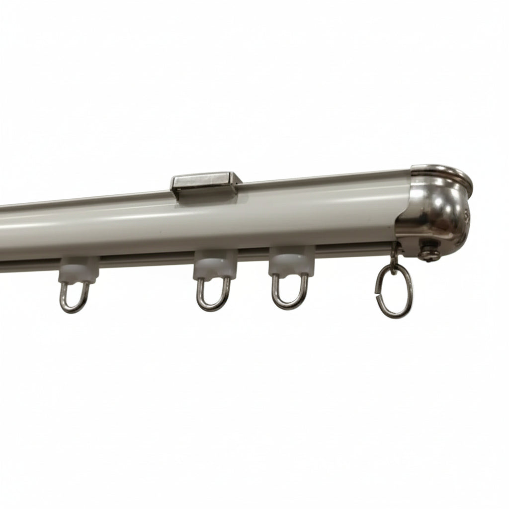 A professional-grade white powder-coated aluminum curtain track featuring high-quality silent sliding gliders and a polished stainless steel end cap. The image highlights the heavy-duty rail profile and durable metal components designed for smooth drapery operation in modern residential and commercial interiors.