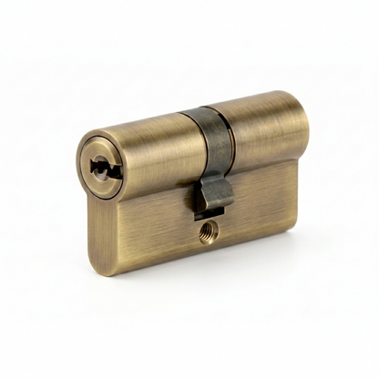 A high-security Euro profile double cylinder door lock barrel in a premium brushed antique brass finish. The image showcases the precision-engineered keyway and central cam, designed with anti-pick and anti-drill protection for luxury residential and commercial door security systems.