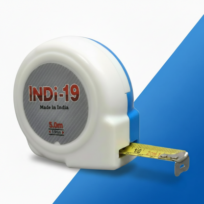 A white and blue INDi-19 measuring tape with a 5.0m length and 19mm blade width, featuring a durable plastic casing and an extended yellow steel tape with metric markings, prominently labeled "Made in India."