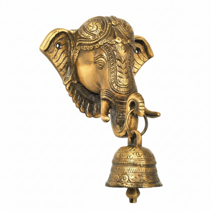 An antique brass wall-mounted hanging bell featuring a highly detailed Lord Ganesha face with an ornate crown and a decorative hanging puja bell, designed for home temple or pooja room decoration.