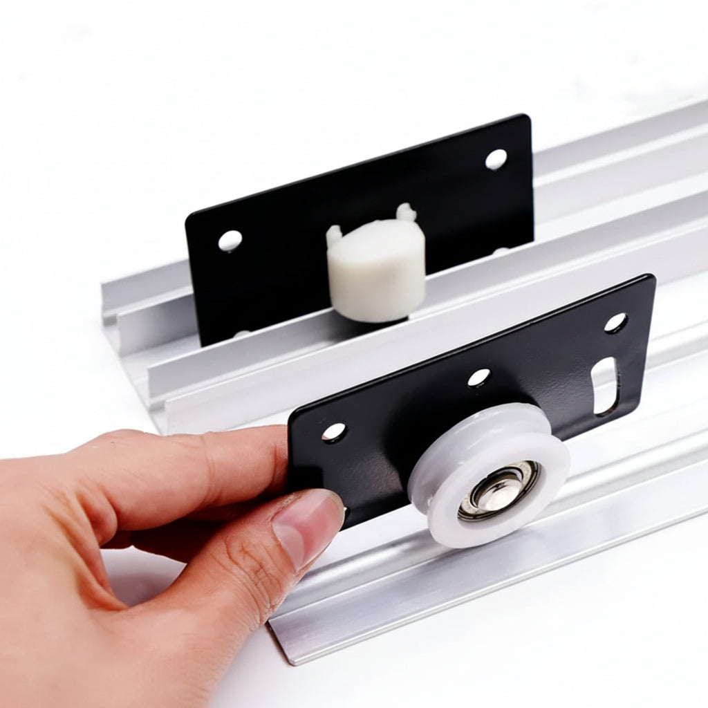 A person demonstrating the installation of a black sliding door roller fitting onto an aluminum track. The image shows the white nylon wheel and metal bracket assembly being aligned with the sliding rail, ideal for wardrobe, cabinet, and closet door hardware systems.