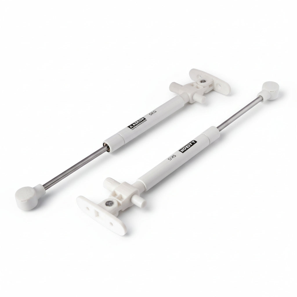 A pair of Aaskon 10-inch soft-close hydraulic gas pumps in a clean white finish, each featuring a 5kg load capacity. These premium pneumatic lift supports include specialized mounting brackets and ball joint connectors, designed to provide smooth, silent, and controlled opening for lightweight cabinet doors and small storage lids.