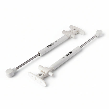 A pair of Aaskon 10-inch soft-close hydraulic gas pumps in a clean white finish, each featuring a 5kg load capacity. These premium pneumatic lift supports include specialized mounting brackets and ball joint connectors, designed to provide smooth, silent, and controlled opening for lightweight cabinet doors and small storage lids.