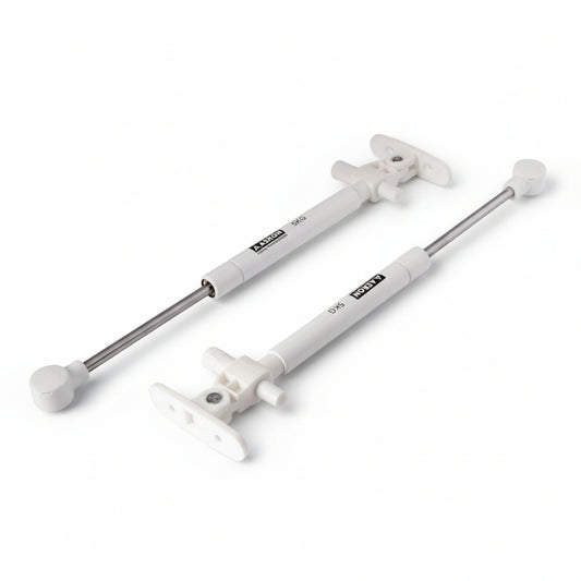 A pair of Aaskon 10-inch soft-close hydraulic gas pumps in a clean white finish, each featuring a 5kg load capacity. These premium pneumatic lift supports include specialized mounting brackets and ball joint connectors, designed to provide smooth, silent, and controlled opening for lightweight cabinet doors and small storage lids.