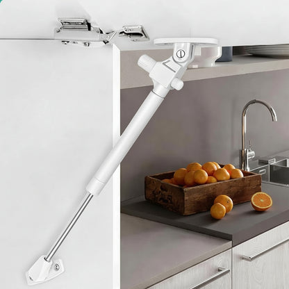 A modern kitchen cabinet installation featuring a white 10-inch soft-close hydraulic gas pump lift support. The image demonstrates the pneumatic strut in action, securely holding an overhead cabinet door open to provide hands-free access to kitchen storage. This professional-grade hardware ensures a controlled, silent closing motion, making it an ideal upgrade for contemporary kitchen cabinetry and space-saving furniture designs.