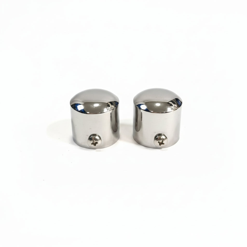A pair of high-quality stainless steel end caps for glass railings featuring a polished chrome finish. These durable balustrade fittings include integrated side screws for secure mounting on round handrail posts, providing a clean and professional finish to modern architectural railing systems.
