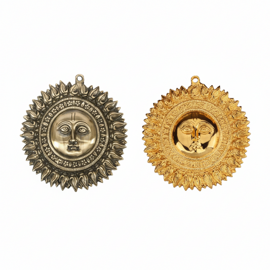 Two decorative Surya Dev (Sun God) wall-mounted accents featuring a central deity face surrounded by radiant sun rays, shown in antique brass and gold finishes for Hindu home temple decoration or Vastu protection at the main entrance.