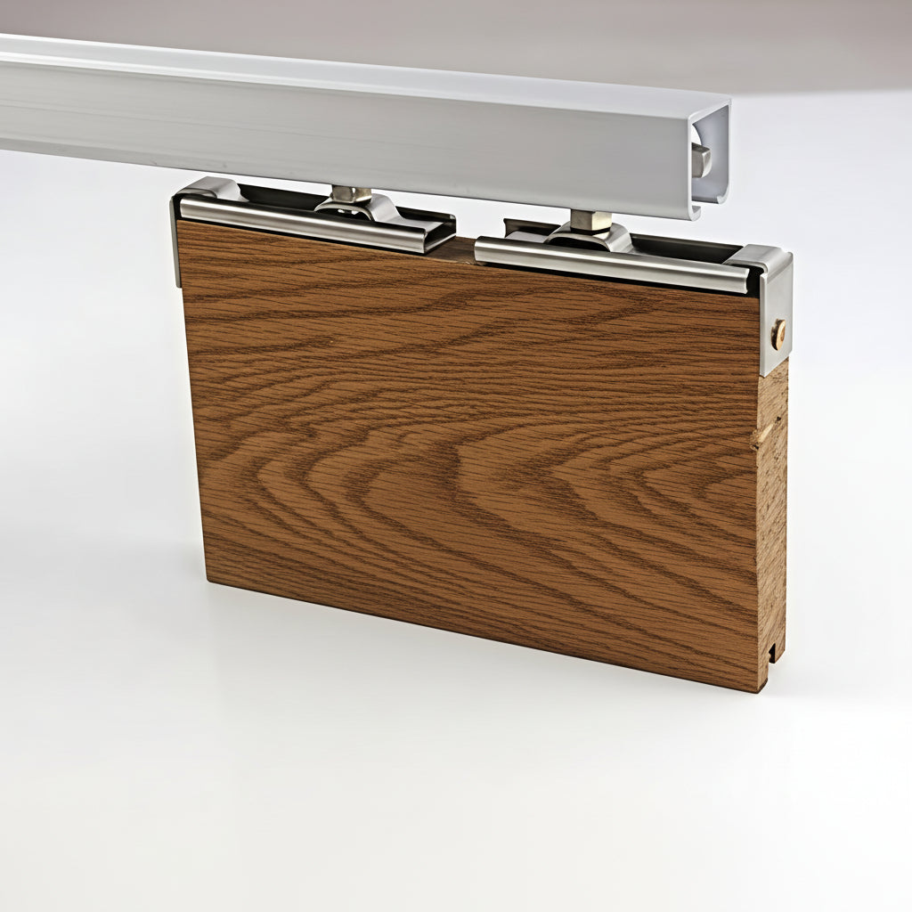 A demonstration of a top-hung sliding door hardware system featuring a heavy-duty aluminum track and stainless steel mounting brackets. The image shows the rollers securely attached to a thick wooden door panel, illustrating a smooth-glide mechanism for interior barn doors, room dividers, and pocket door installations.